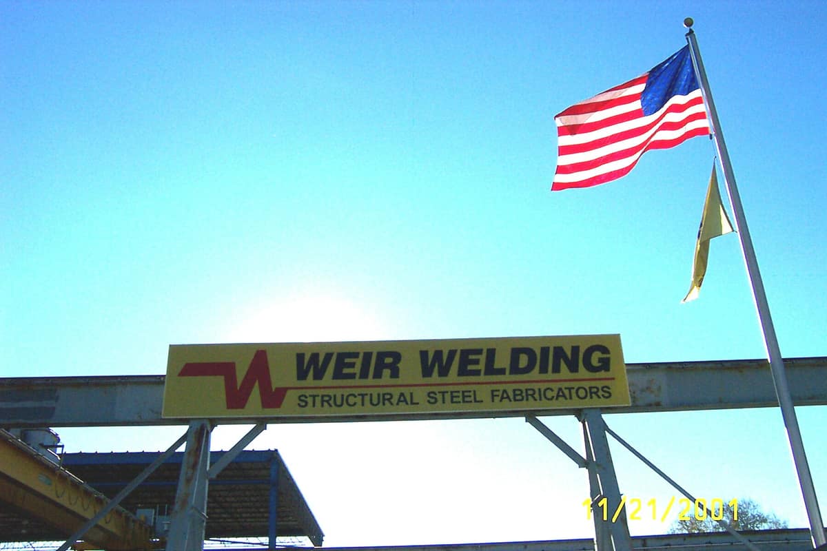Weir Welding facility sign with American flag